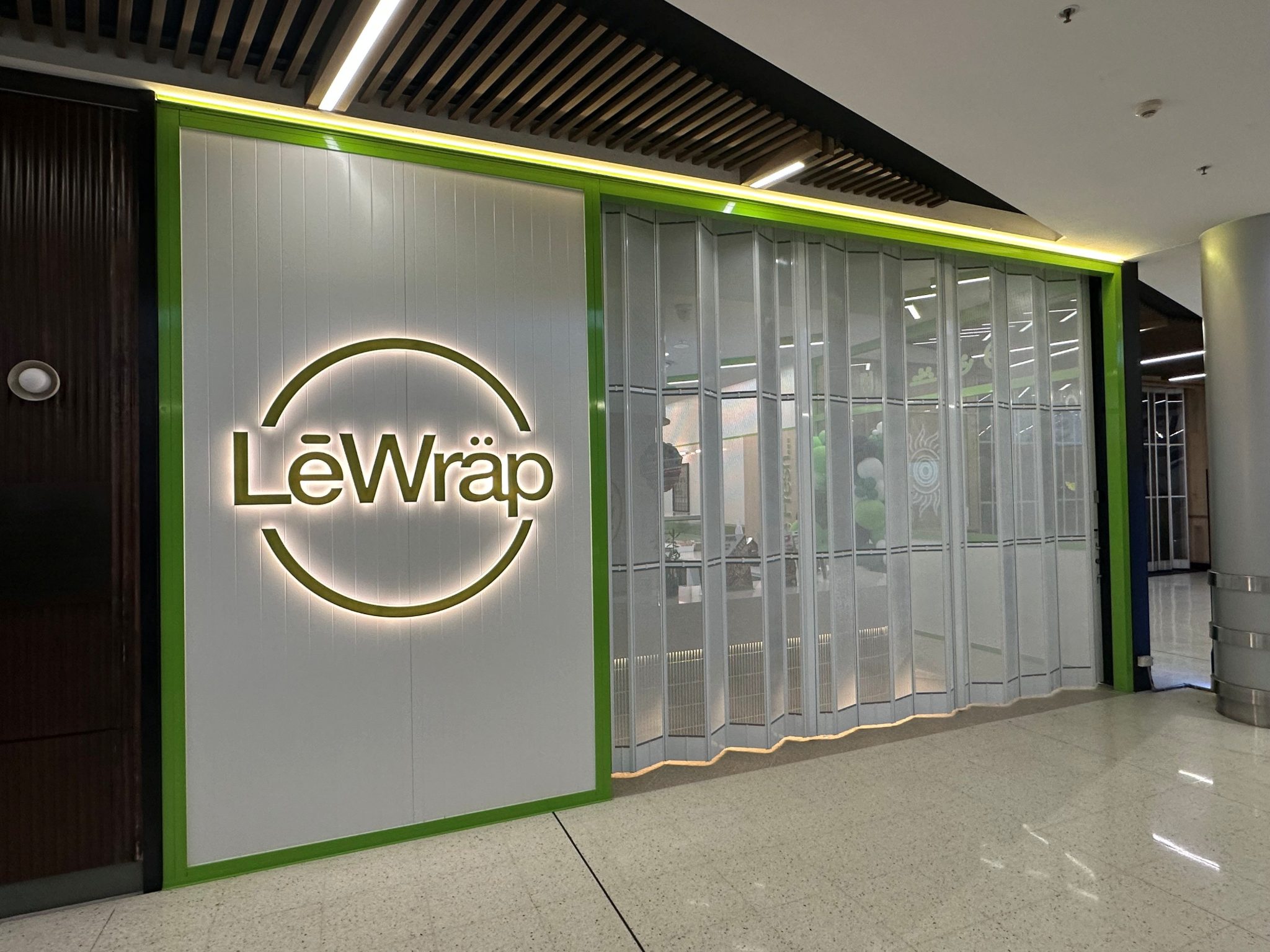 Perforated Mesh Infill Retail Folding Doors for Le Wrap Australia